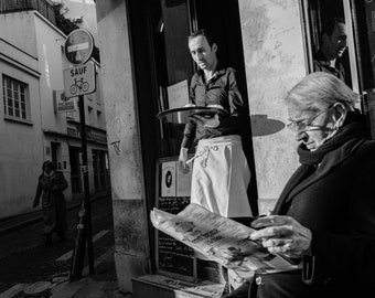 Black and white photograph - Waiter serving at the Café des Deux Moulins, Paris, which features in the movie, "Amelie".