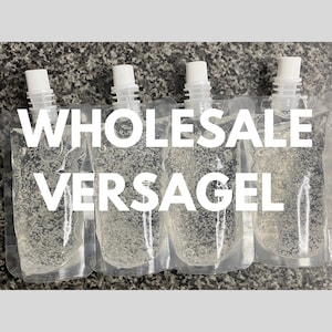 May include: Four transparent pouches filled with a gel-like substance, each with a white spout. The pouches are arranged in a row, with the text "WHOLESALE VERSAGEL" in large white letters across the image.