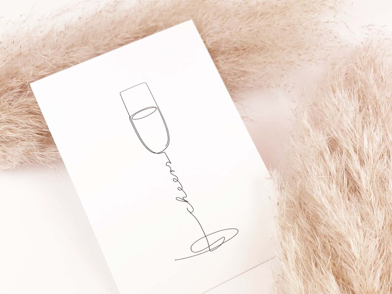 May include: A simple line drawing of a champagne flute with the word "cheers" written in cursive below it. The drawing is on a white background.