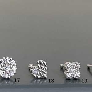 May include: A set of ten silver-toned earrings with various crystal designs. The earrings are numbered 16 through 20.