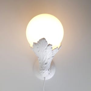 Sculptural porcelain wall lamp, ceramic leaves with glass ball lamp