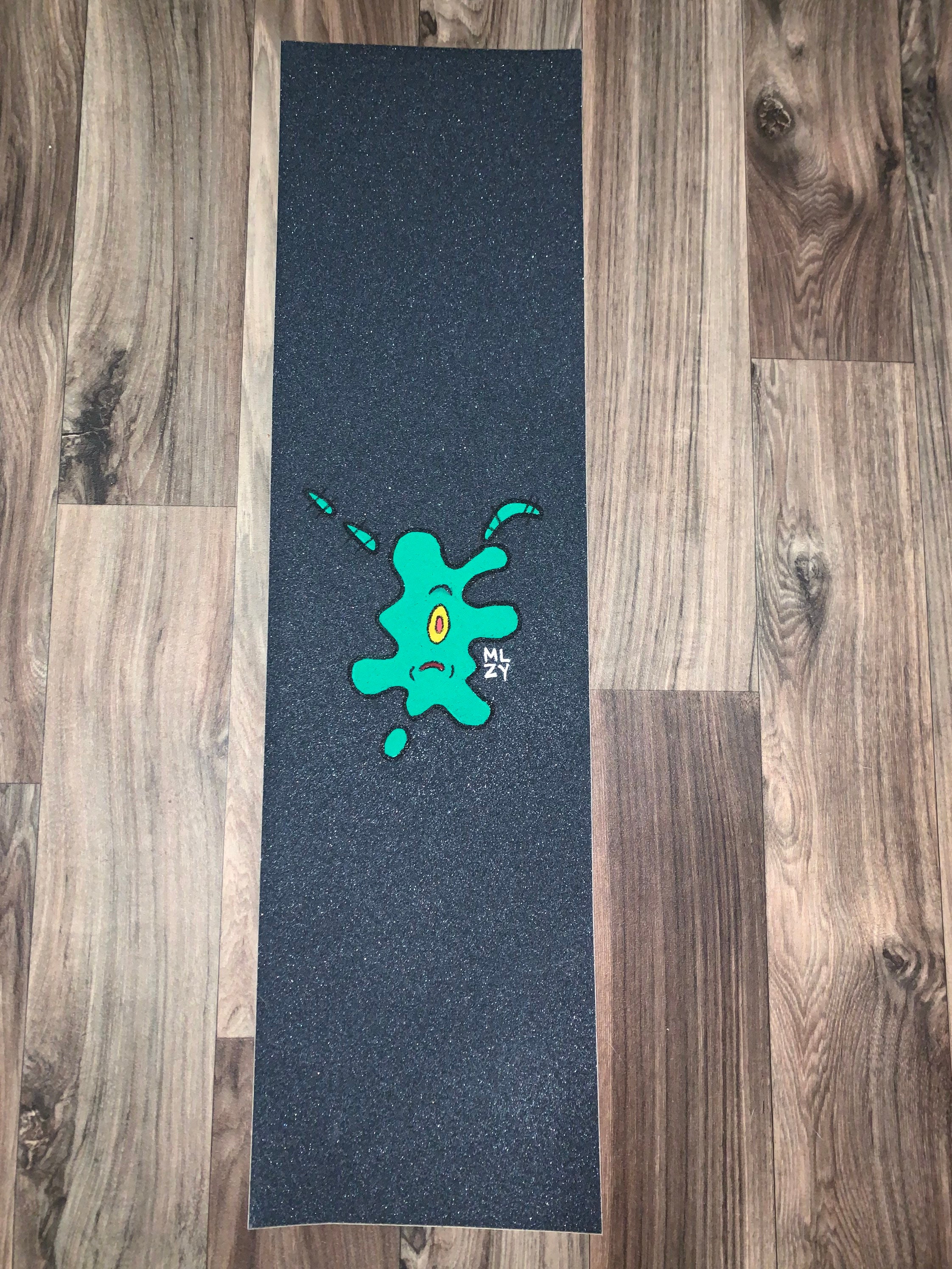 First time Applying and making a custom grip tape using clear grip tape , a  Grip tape of Pluto and a random Polaroid with the color green to cover a  lil bit