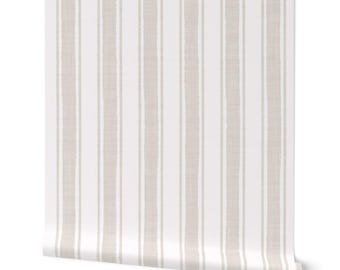 May include: A roll of wallpaper featuring a vertical stripe pattern. The design alternates between wide, textured beige stripes and narrower white stripes. The wallpaper is partially unrolled, revealing the pattern.