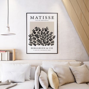 May include: A black and white poster with the text "MATISSE AIX-EN-PROVENCE" and a black and white illustration of a cluster of leaves. The text "BERGGREEN & CIE 76, RUE DE L'UNIVERSITE, PARIS" is at the bottom of the poster.