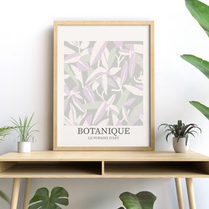 May include: A framed print with a botanical design featuring abstract leaves in shades of green, purple, and white. The print has the text "BOTANIQUE LE FORMES D'ART" at the bottom.