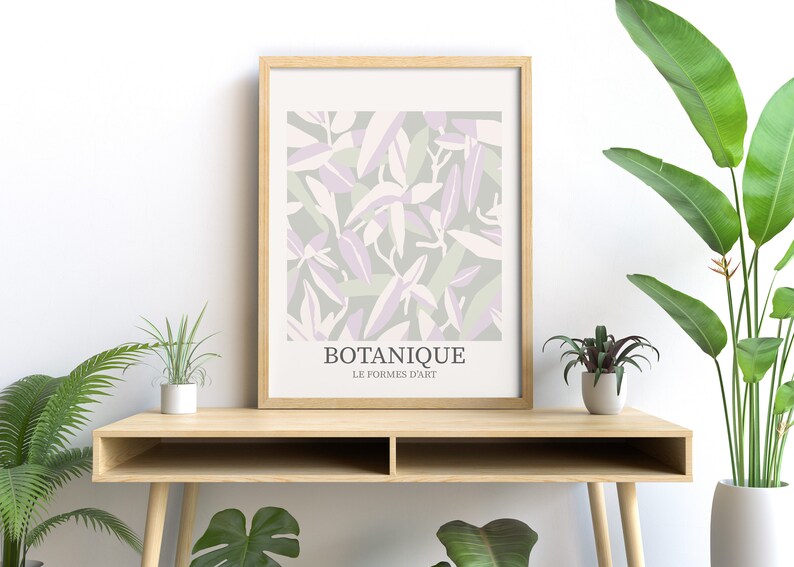May include: A framed print with a botanical design featuring abstract leaves in shades of green, purple, and white. The print has the text "BOTANIQUE LE FORMES D'ART" at the bottom.