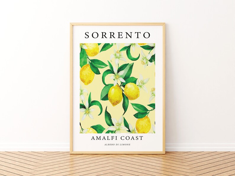 May include: A framed print with a yellow background featuring a watercolor illustration of lemons and white flowers. The text "SORRENTO AMALFI COAST ALBERO DI LIMONE" is printed in black at the top and bottom of the print.