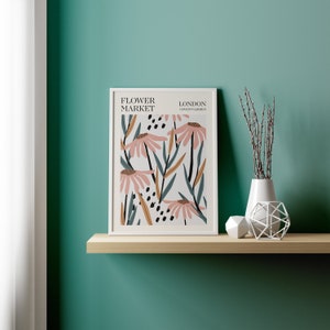 May include: A white framed print with a floral design featuring pink flowers and green leaves. The print has the text "FLOWER MARKET LONDON COVENT GARDEN" at the top.