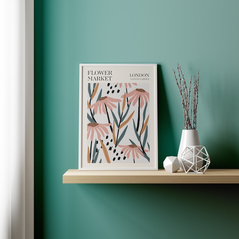 May include: A white framed print with a floral design featuring pink flowers and green leaves. The print has the text "FLOWER MARKET LONDON COVENT GARDEN" at the top.