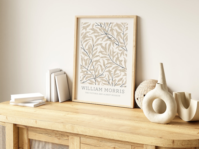 May include: A framed print of a botanical illustration with a beige background and blue accents. The print features the text "William Morris" and "The Victoria and Albert Museum".
