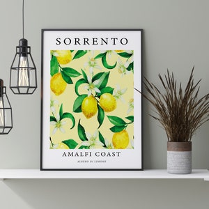 May include: A framed print with a yellow background and a pattern of lemons, green leaves, and white flowers. The text "SORRENTO AMALFI COAST ALBERO DI LIMONE" is printed on the print.