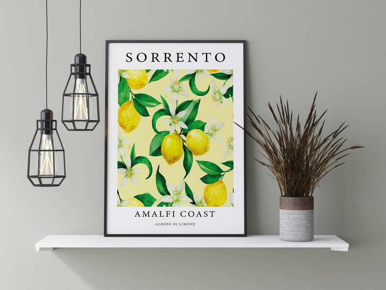 May include: A framed print with a yellow background and a pattern of lemons, green leaves, and white flowers. The text "SORRENTO AMALFI COAST ALBERO DI LIMONE" is printed on the print.