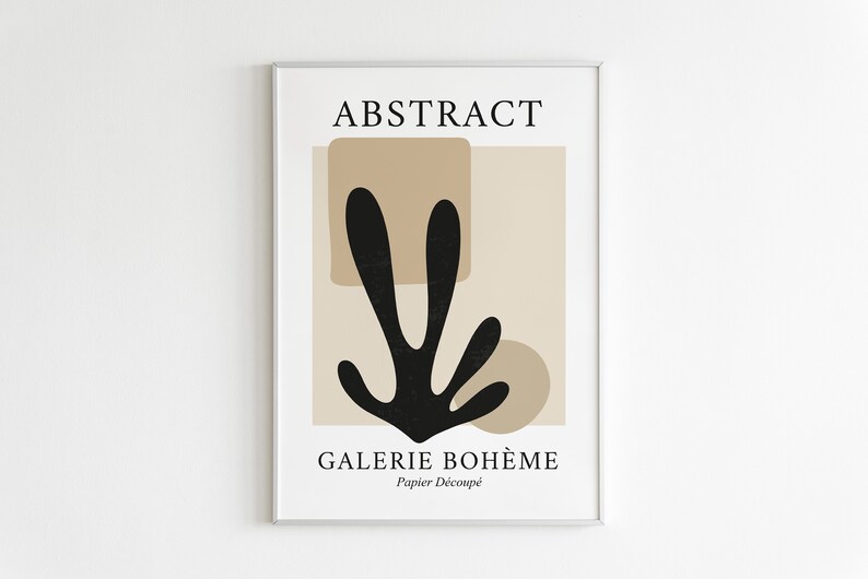 May include: A framed print with the text "ABSTRACT" and "GALERIE BOHEME" in black text on a beige background. The print features a black abstract shape resembling a plant with brown geometric shapes behind it. The text "Papier Decoup&eacute;" is also included.