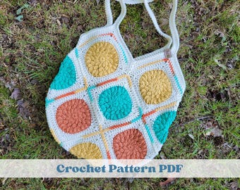 May include: A handmade crochet tote bag featuring a series of square motifs with circular centers in mustard yellow, teal, and burnt orange, all joined by cream-colored yarn. The bag includes two shoulder straps and the text Crochet Pattern PDF.