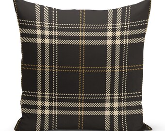 May include: Black throw pillow with a white and gold plaid pattern.