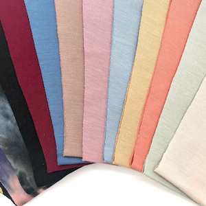 This is an image of our CPAP chin straps arranged in a fan shape, showcasing their different colors and textures.
