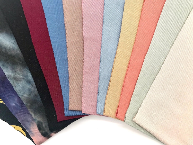This is an image of our CPAP chin straps arranged in a fan shape, showcasing their different colors and textures.