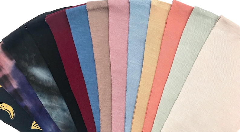 This is an image of our CPAP chin straps arranged in a fan shape, showcasing their different colors and textures.
