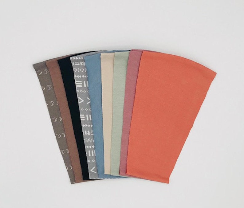 This is an image of our CPAP chin straps that allows you to see all of the colors we offer; moons pattern/grey, mocha, black, tribal pattern/grey, dusty blue, bone, sage, rose, & tangerine.