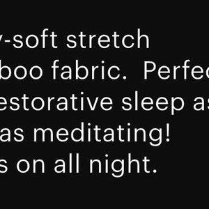 May include: Text on a black background reads: "Cozy-soft stretch bamboo fabric. Perfect for restorative sleep as well as meditating! Stays on all night."