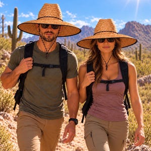 May include: Two wide-brimmed straw hats with black trim and adjustable chin cords, worn with dark sunglasses, olive green and mauve tank tops, khaki cargo trousers, and black backpacks in a desert landscape with cacti and mountains.
