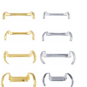 May include: Four pairs of orthodontic separators, two gold and two silver. The separators are designed to create space between teeth for braces.