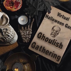 May include: A vintage-style card with the text "Virtual Halloween Game: Ghoulish Gathering" printed on it. The card is decorated with a small skull illustration and is lying on a black surface with a skull, candles, and other Halloween decorations.