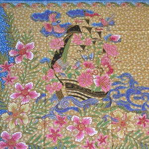 May include: A gold fabric with a repeating pattern of blue waves, pink flowers, and black ships. The ships have white sails and are decorated with pink flowers. The fabric has a traditional Indonesian batik style.