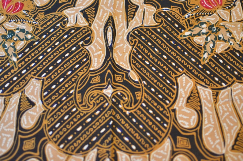 May include: A black fabric with a repeating pattern of gold and white stylized floral designs. The pattern is intricate and detailed, with a symmetrical design.