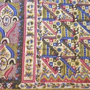 May include: A colorful fabric with a geometric pattern in shades of blue, red, green, and gold. The fabric has a floral design with intricate details.