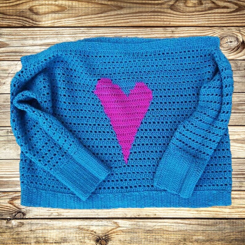 Pu&ograve; includere: Un maglione di lana blu con un design a forma di cuore rosa.