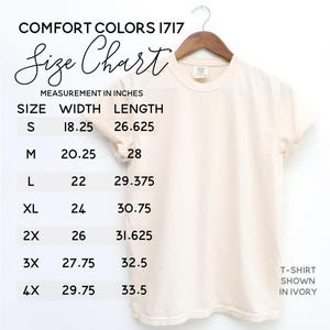 May include: A cream-colored t-shirt hanging on a wooden hanger, with a size chart displayed. The chart lists sizes S to 4X, with width and length measurements in inches. The text "COMFORT COLORS 1717" and "Size Chart" are visible.