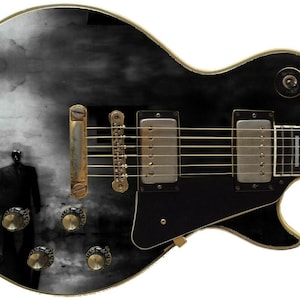 May include: Black electric guitar with a custom design featuring a black and white image of a person walking past a street lamp in a foggy city.