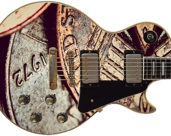 May include: A vintage-style electric guitar with a custom design featuring a close-up of a US penny with the year 1972 printed on it.