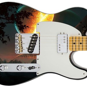 May include: A black electric guitar with a white pickguard. The guitar has a custom design featuring a fiery orange planet and a dark silhouette of a tree in the background.