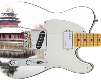 May include: A white electric guitar with a snow scene of a red Chinese pagoda reflected in a body of water. The guitar has a maple fretboard and gold hardware.