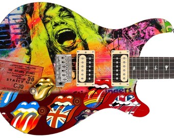 May include: A red electric guitar with a colorful design featuring a portrait of a man with a tongue sticking out, a rainbow, and the words "The Rolling Stones".