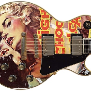May include: A black electric guitar with a custom design featuring a vintage magazine cover with a couple on the front. The magazine cover features the text "...what must a good girl say MIGHT CHOO CA JE FACTS ABOUT TABOO AT GIVE THEM WHAT".