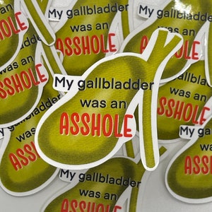 May include: Multiple stickers with a green pear-shaped design and the text "My gallbladder was an ASSHOLE" in black and red lettering.