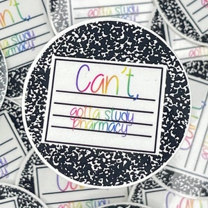 May include: A round sticker with a black and white notebook paper design. The sticker has a white rectangle with the text "Can't" in rainbow colors and the text "gotta study pharmacy" in rainbow colors below it.