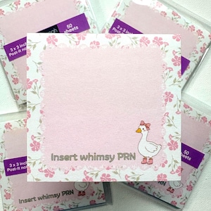 May include: A square sticky note pad featuring a light pink center with a scalloped border, surrounded by a white frame with a pink floral pattern. A white goose wearing a pink bow and pink boots is printed on the bottom right with the text Insert whimsy PRN.