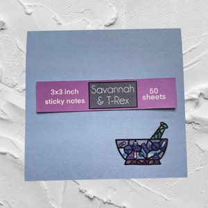 May include: A pack of 50 3x3 inch sticky notes featuring a colorful mortar and pestle design. The pack is labeled "Savannah & T-Rex".