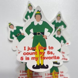 May include: A white sticker with a cartoon image of Buddy the Elf from the movie Elf. Buddy is wearing his green elf uniform and holding a knife. The sticker has the text "I just like to count by 5s, 5 is my favorite" in red and black text.