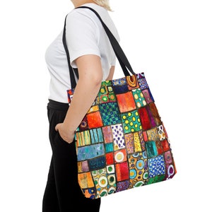 May include: A colorful tote bag with a patchwork design featuring squares and circles in various shades of red, orange, yellow, green, blue, and purple.