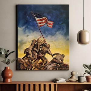 May include: A framed print of the iconic image of the raising of the American flag on Iwo Jima. The artwork depicts U.S. Marines raising the flag against a backdrop of a blue sky and a yellow-orange horizon. The flag is red, white, and blue.