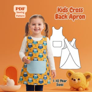 May include: A child wearing a yellow owl-patterned apron with a light blue pocket. The apron is part of a PDF sewing pattern for kids' cross-back aprons, available in sizes for 1-10 year olds. The image also shows a teddy bear and the text "Kids Cross Back Apron".