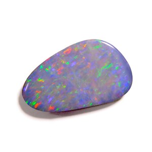 May include: A polished, teardrop-shaped opal gemstone featuring a dark blue base color with vibrant, multi-colored flashes of green, orange, and purple light throughout its surface. The stone has a smooth, reflective finish and irregular edges.