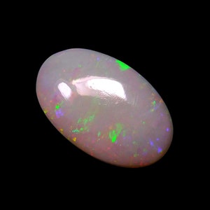 May include: A white opal gemstone with green and purple flashes of color. The oval-shaped stone is set against a black background.