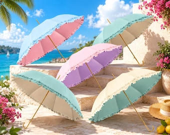May include: Five parasols with ruffled edges and gold-toned metal shafts. The umbrellas feature solid pastel colors including light blue, pink, mint green, lavender, and cream. Each parasol has a curved handle and a canopy with a decorative trim.