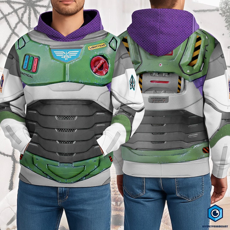 A man wearing a futuristic-looking hooded jacket with a green and purple color scheme, along with various patches and insignia.